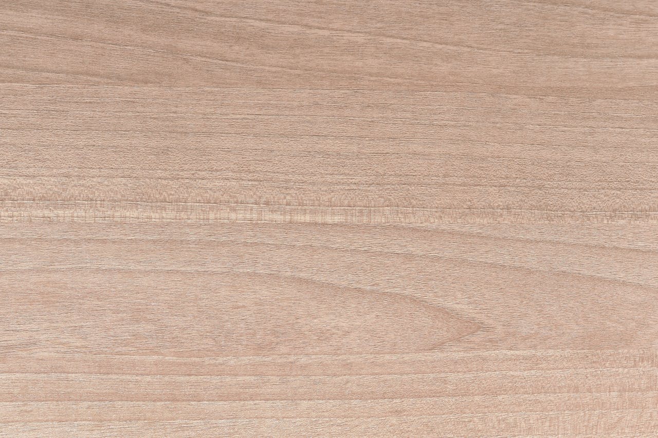 Light brown wood surface with a natural grain, ideal for backgrounds or design projects.