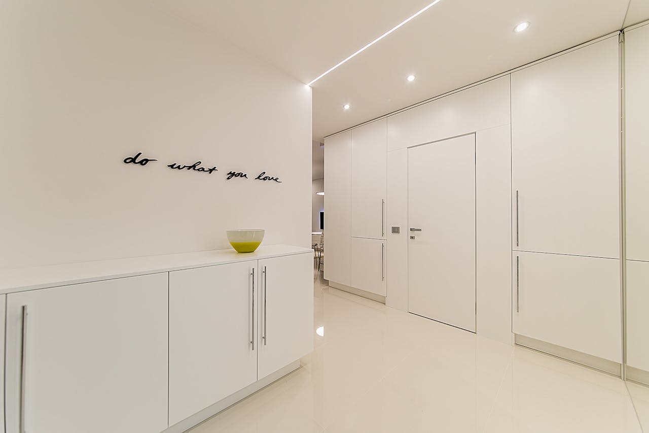 Sleek and modern minimalistic white room with motivational text and stylish decor bowl.